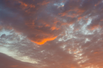 Landscape with dramatic light - beautiful golden sunset with saturated sky and clouds.