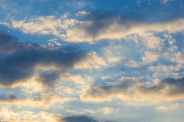 Landscape with dramatic light - beautiful golden sunset with saturated sky and clouds.