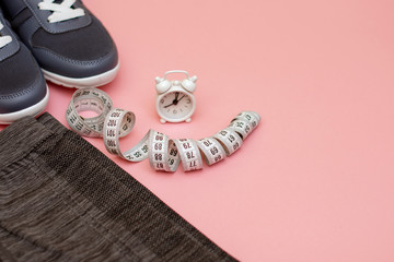 Concept - sports accessories and watches to remind you of sports on a pink background. copy space