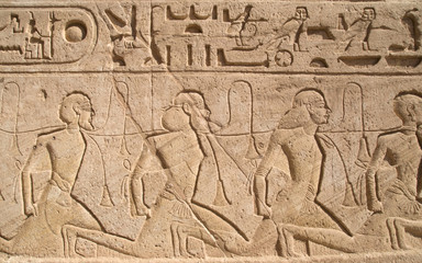 Fototapeta na wymiar Relief depicting a row of captives in Abu Simbel temple of Ramesses II, Egypt