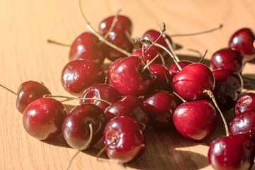 Sweet cherry (black cherry) on a wooden table