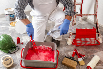 Professional house painter at work prepares the wall paint © francescomou