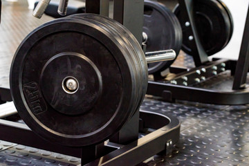 Fitness dumbbell and barbell weight plates in gym close