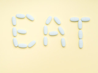 Blue pills supplements spelling word Eat