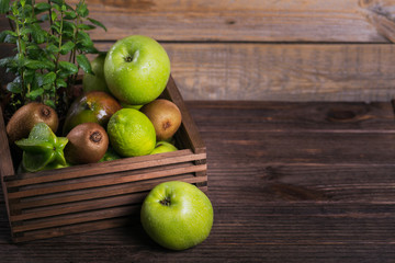 Set of green fruits for healthy diet and detox: apple, lime, kiwi, mango, carambola and mint.