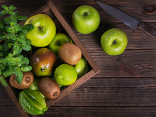 Fototapeta na wymiar Set of green fruits for healthy diet and detox: apple, lime, kiwi, mango, carambola and mint.