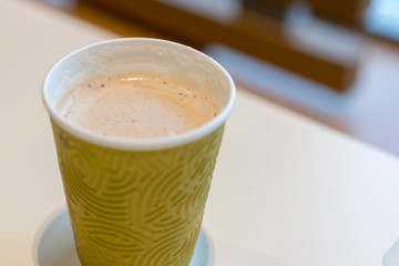 Coffee with milk in a paper glass