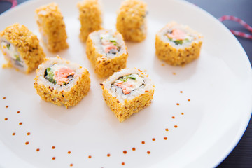Fresh tasty sushi on a white plate close up. View from above.