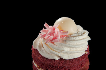 Close-up of a mini cake on black background