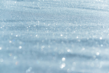 Sparkling snow in the sunlight. View of snow with blur and bokeh. Partial focus away