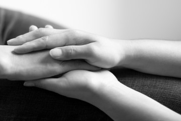 Black and white photo of hands holding together; concept of hope and encourage.