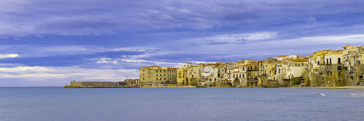 Fototapeta premium Houses along the shoreline and cathedral in background Cefalu Sicily. Italy.