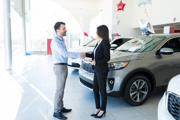 Customer Contacting Car Dealer With A Handshake