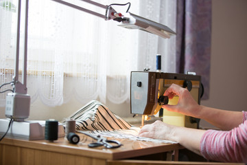 woman hands using sewing machine on a sewing manufacture, sewing process