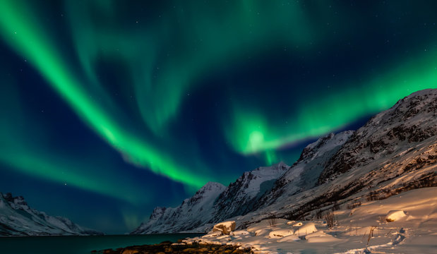 Amazing Aurora Borealis in North Norway (Kvaloya), mountains in the background