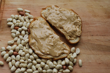 Delicious peanut butter sandwich breakfast and peanut on wooden table background. Sweet food, breakfast concept