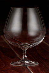 A cognac glass on a wooden table
