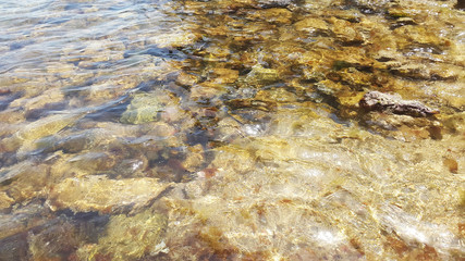 yellow stones in transparent water near Budva - Montenegro coast