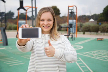 Positive girl standing on sports ground
