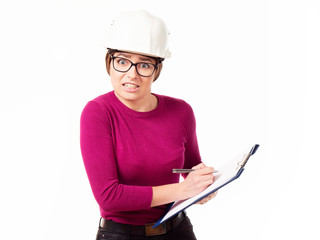 Fototapeta premium Emotional girl brigadier in a white helmet with glasses and a folder in his hands on a white background