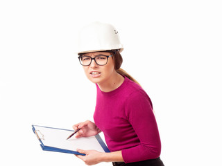 Emotional girl brigadier in a white helmet with glasses and a folder in his hands on a white background