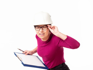 Emotional girl brigadier in a white helmet with glasses and a folder in his hands on a white background