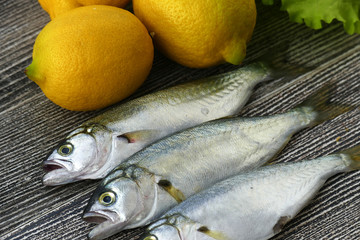 small bluefish and lemon, on wooden background