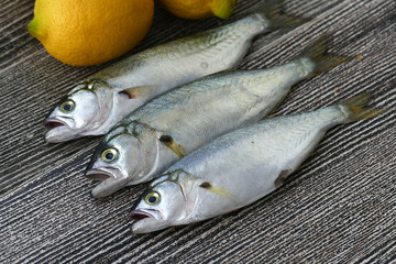 small bluefish and lemon, on wooden background