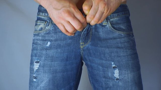 Man unzips his jeans. Close-up. 1920X1080 Full Hd.