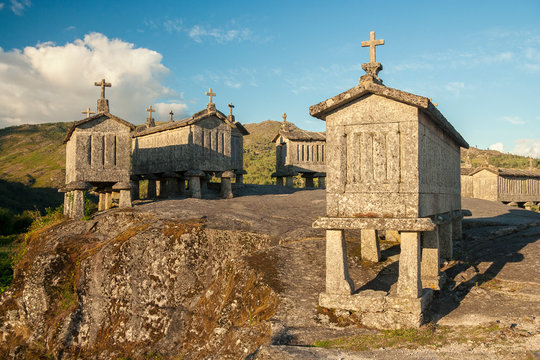 Portugal - Braga - The group of espigueiros (raccards or granaries lifted to be protected against rodents) crowned with crosses on the stone hill in Soajo settlement of Peneda-Geres national park