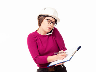 Emotional girl brigadier in a white helmet with glasses and a folder in his hands on a white background