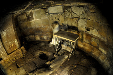 dimly lit ancient roman prison cell