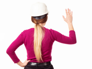 Emotional girl brigadier in a white helmet with glasses and a folder in his hands on a white background