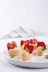 Sweet  waffle basket with cream cheese  and strawberries for summer  breakfast  over white background