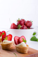 Sweet  waffle basket with cream cheese  and strawberries for summer  breakfast  over white background