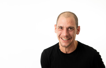 Obraz premium Close up portrait of smiling attractive young man with happy face looking at the camera
