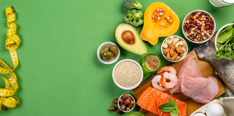 Mediterranean diet concept - meat, fish, fruits and vegetables on bright green background