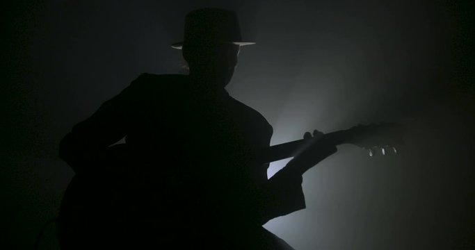 Man playing electric guitar solo silhouette