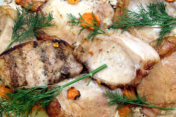 Appetizing fried pork meat pieces with carrot top view closeup