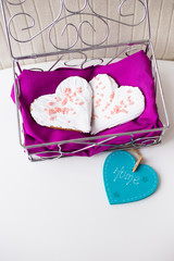 Cookies in the form of heart on a pink napkin inscription home