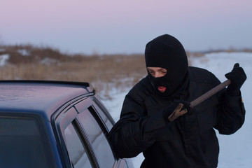 Crime scene - A thief in a black mask, the crowbar broke the glass of the machine. theft auto...