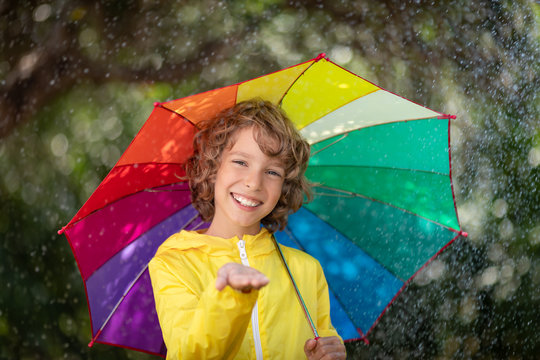 Happy child playing in the rain