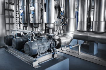 pipe lines with steam supply pumps and pressure gauges installed in the boiler room	