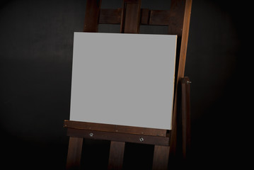 The canvas on the easel on the black background