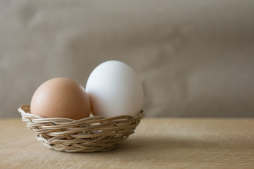 White and brown eggs in a basket