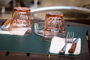 Table cafe with by two glass and fork, knife and napkin.