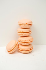 Peach macaroons, almond cookies with peach juice, lined in a column