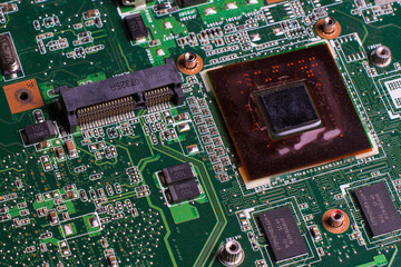 Laptop motherboard microcircuit closeup. Computer electronic parts background. Technology, science and electronics concept