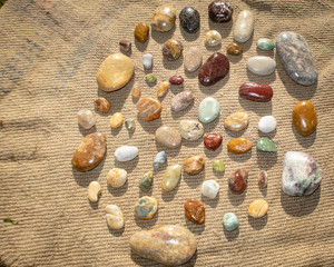 A collection of coloured stones and agates collected from the beach at Birdlings Flat, Canterbury,...