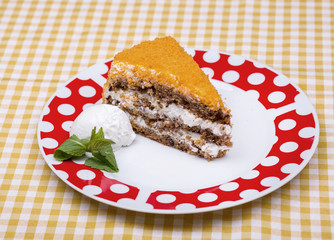 carrot pie with walnuts, prunes and dried apricots. On a white plate. One piece